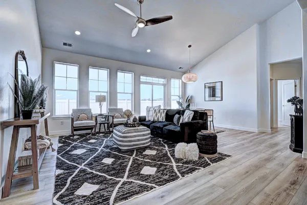 a living room with furniture and a wooden floor