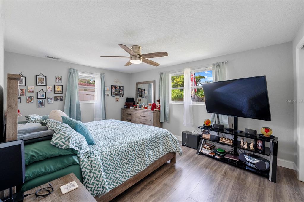 2152 Arcadia Road Holiday, FL 34690 - Photo 16 of 30 a bedroom with a bed furniture and a flat screen tv