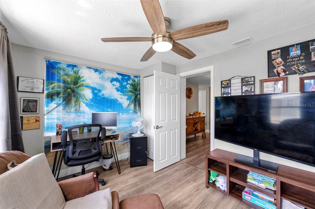 2152 Arcadia Road Holiday, FL 34690 - Photo 20 of 30 a living room with furniture and a flat screen tv