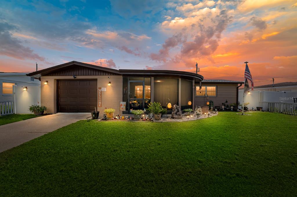 2152 Arcadia Road Holiday, FL 34690 - Photo 2 of 30 a front view of a house with patio and garden