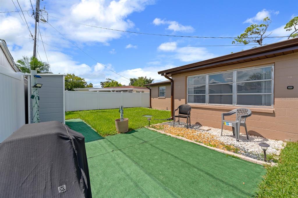 2152 Arcadia Road Holiday, FL 34690 - Photo 22 of 30 a view of a house with backyard and sitting area