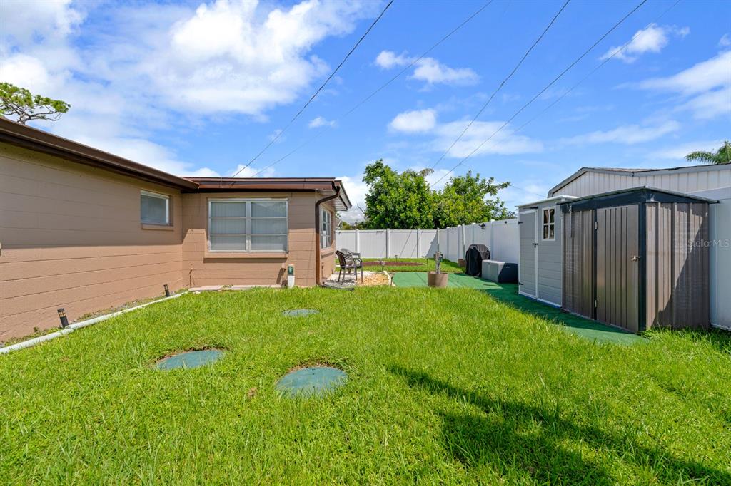 2152 Arcadia Road Holiday, FL 34690 - Photo 24 of 30 a backyard of a house with table and chairs