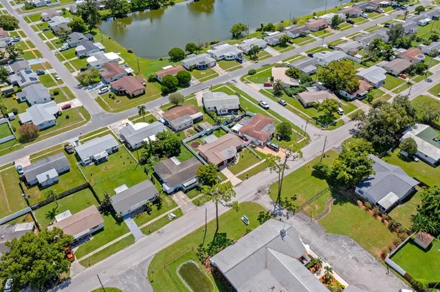 an aerial view of a houses with yard