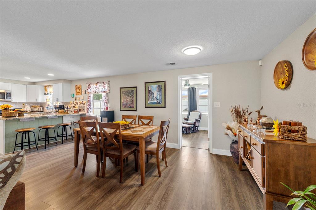 2152 Arcadia Road Holiday, FL 34690 - Photo 7 of 30 a view of a dining room with furniture and wooden floor