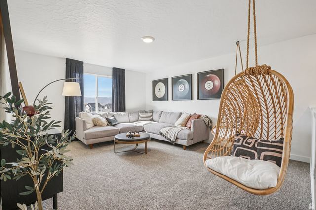 2097 North Ostler Peak Road, Unit 115 Heber City, UT 84032 - Photo 2 of 33 Carpeted living area featuring a large window, recessed lighting, and a built-in hanging chair