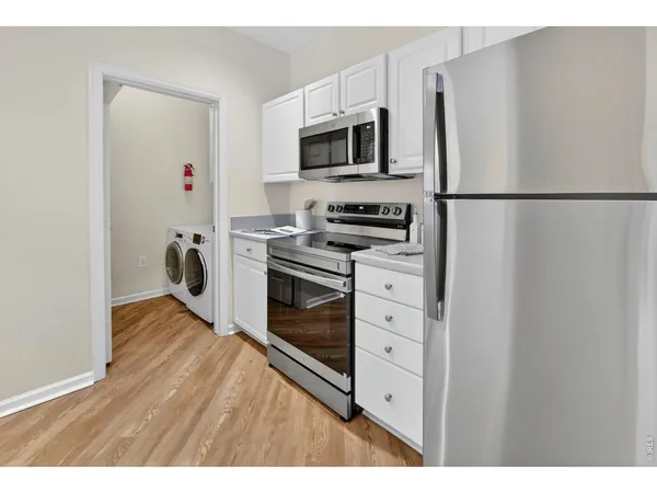 a kitchen with stainless steel appliances a refrigerator stove and microwave