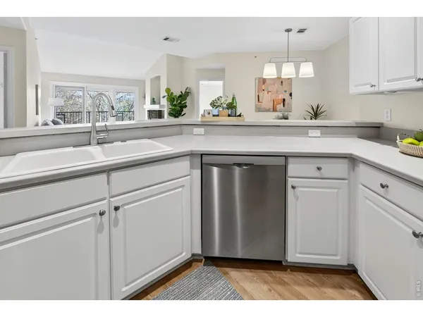 a kitchen with a sink cabinets and window