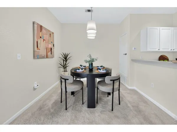 a dining room with furniture and window