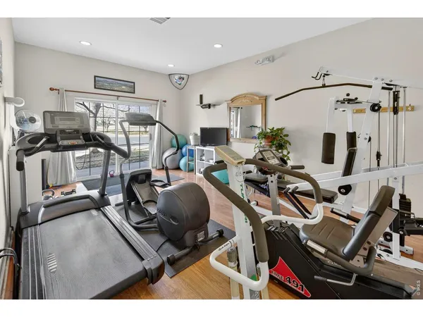 a room with gym equipment and view of living room
