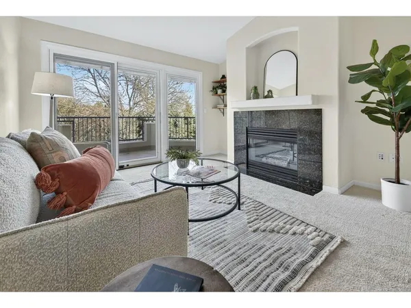 a living room with furniture a window and a fireplace