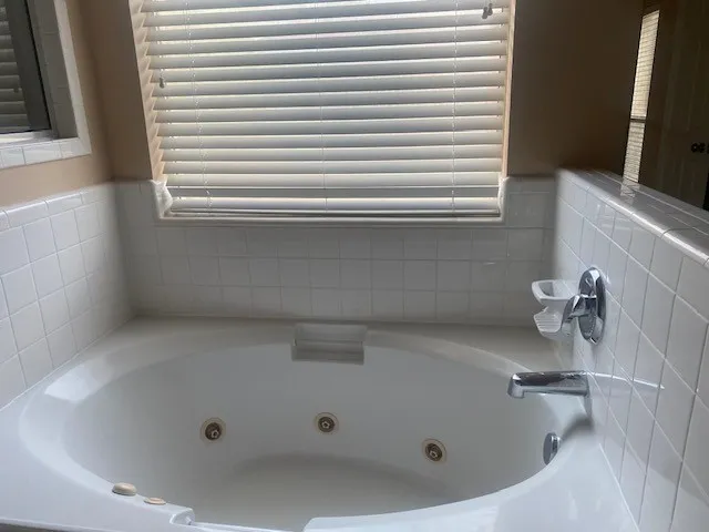 a white toilet sitting next to a shower