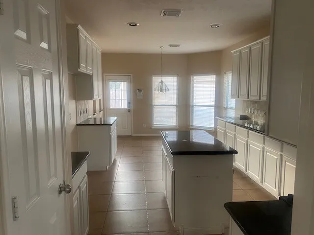 a kitchen with stainless steel appliances a refrigerator a sink dishwasher and a stove with wooden floor