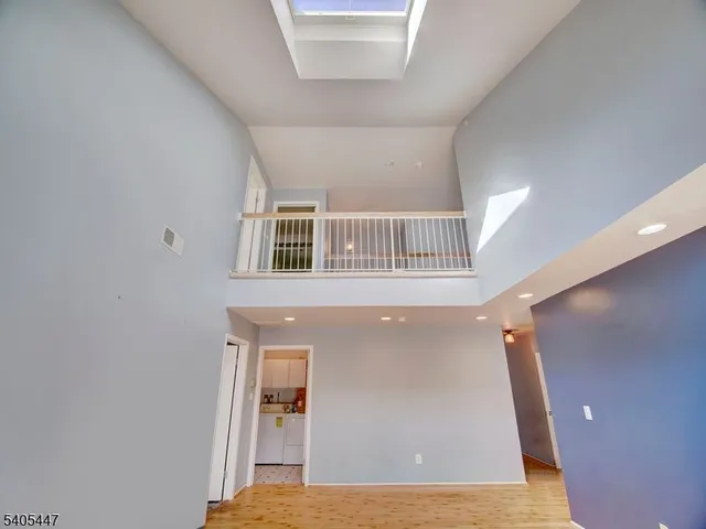 a view of a livingroom with wooden floor and staircase