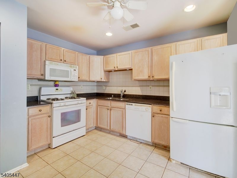 30 Pasture Court Ledgewood, NJ 07852 - Photo 5 of 24 a kitchen with granite countertop cabinets and white appliances