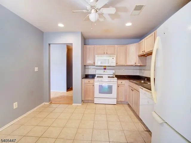 a kitchen with a stove a sink and a refrigerator