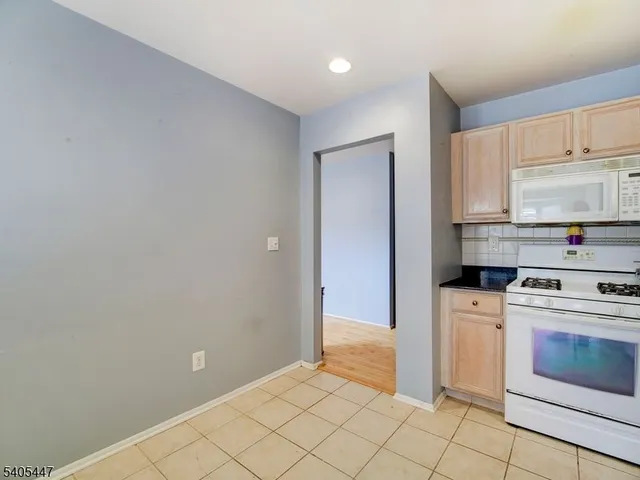 a kitchen with a stove top oven and cabinets