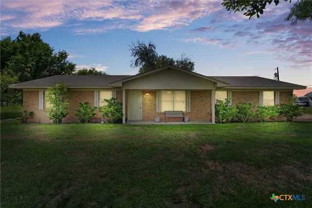 a view of a front of a house with a yard
