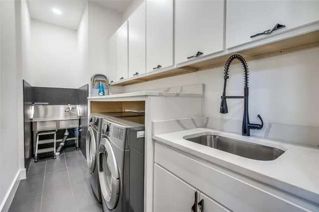 a utility room with sink dryer and washer