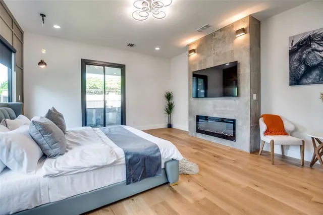 a bedroom with a bed and a flat screen tv