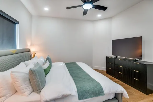 a bedroom with a bed and a flat screen tv