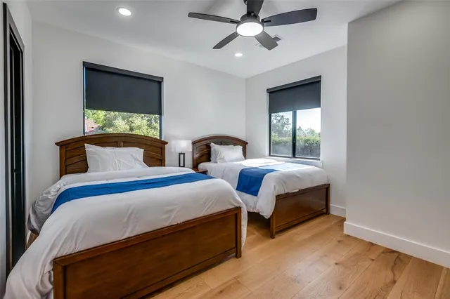 a bedroom with two beds and a chandelier