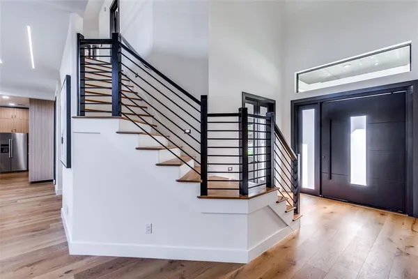 a view of entryway and hall with wooden floor