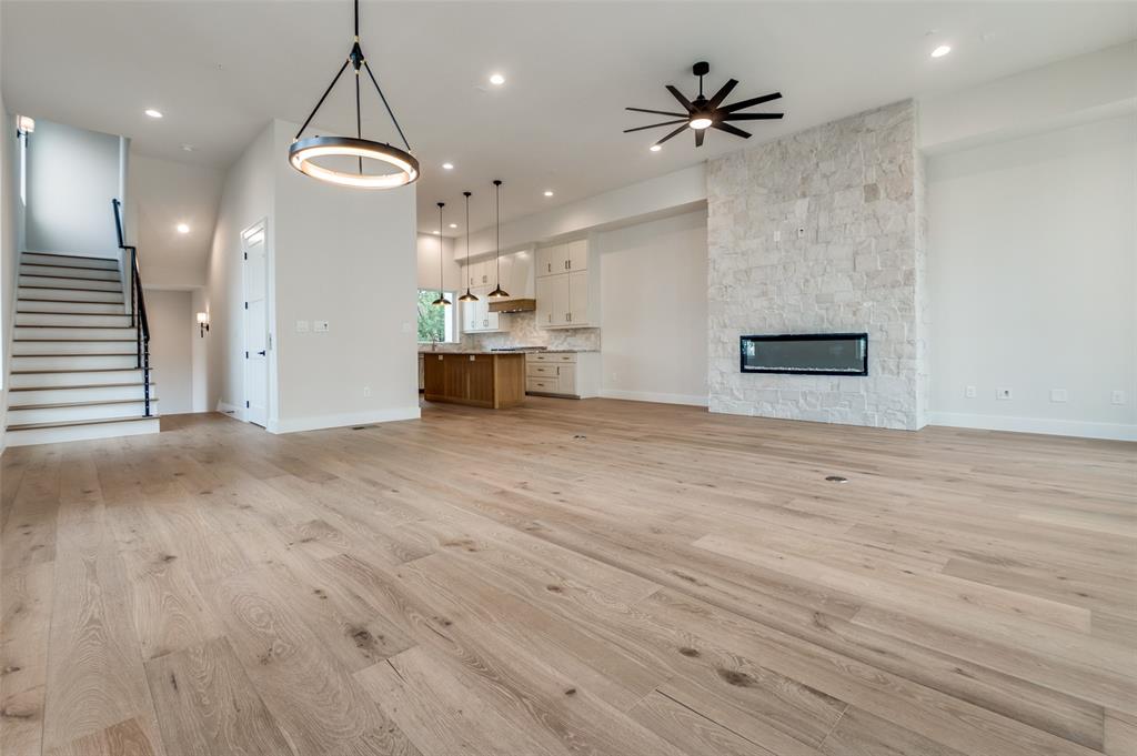 250 East Dallas Road, Unit 121 Grapevine, TX 76051 - Photo 12 of 34 an empty room with wooden floor and a ceiling fan