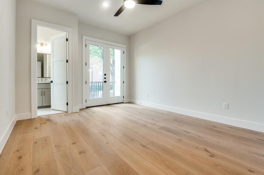250 East Dallas Road, Unit 121 Grapevine, TX 76051 - Photo 19 of 34 an empty room with wooden floor and windows
