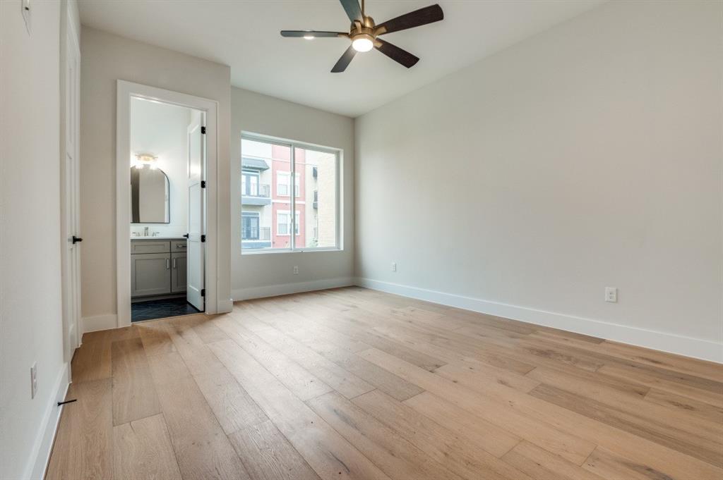 250 East Dallas Road, Unit 121 Grapevine, TX 76051 - Photo 21 of 34 wooden floor in an empty room with a window