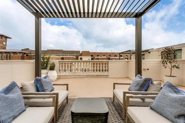 a view of an chairs and table in the balcony