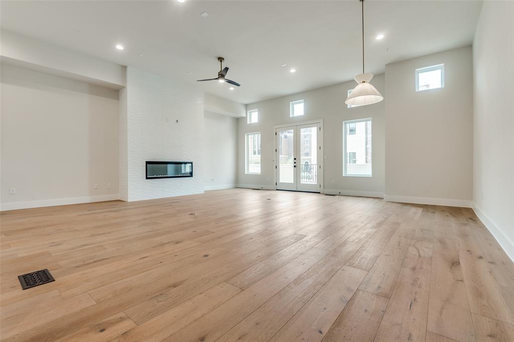 250 East Dallas Road, Unit 121 Grapevine, TX 76051 - Photo 10 of 34 an empty room with wooden floor and windows