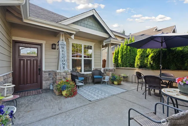 a view of a patio with couches table and chairs and potted plants