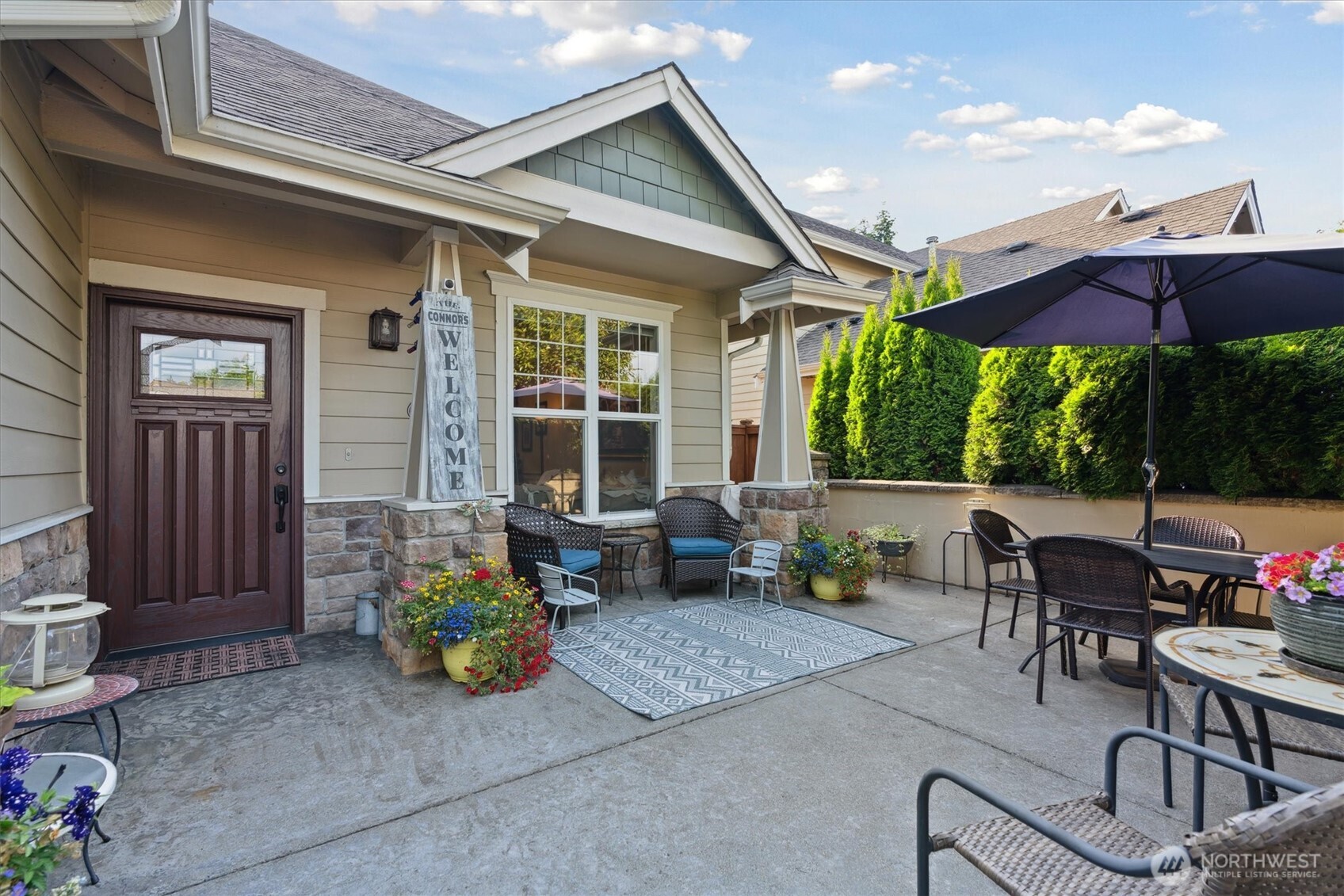 26713 178th Loop Southeast Covington, WA 98042 - Photo 1 of 30 a view of a patio with couches table and chairs and potted plants