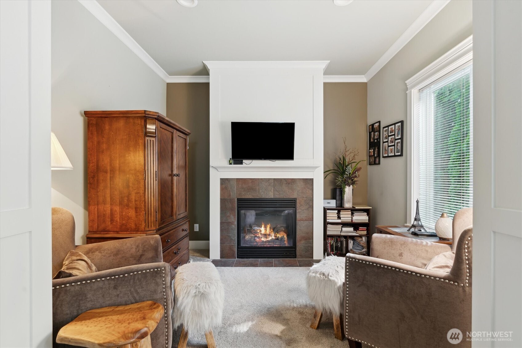 26713 178th Loop Southeast Covington, WA 98042 - Photo 13 of 30 a living room with furniture a flat screen tv and a fireplace