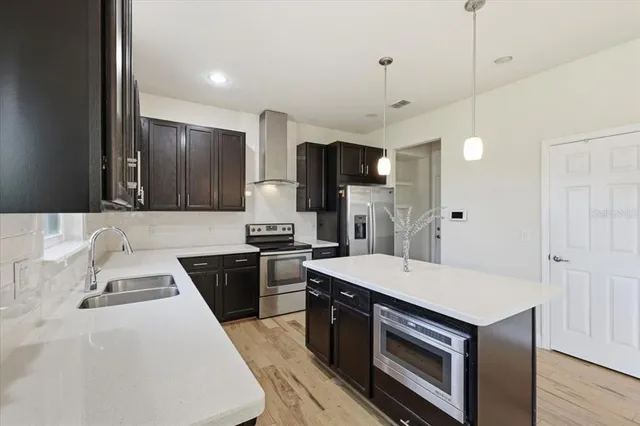 a kitchen with a stove sink and refrigerator