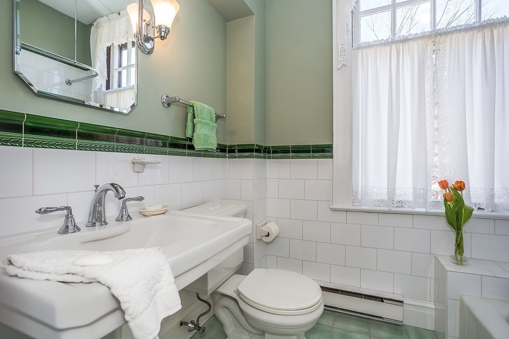 100 Pond Street, Unit 6 Boston, MA 02130 - Photo 15 of 29 a bathroom with a toilet sink and mirror