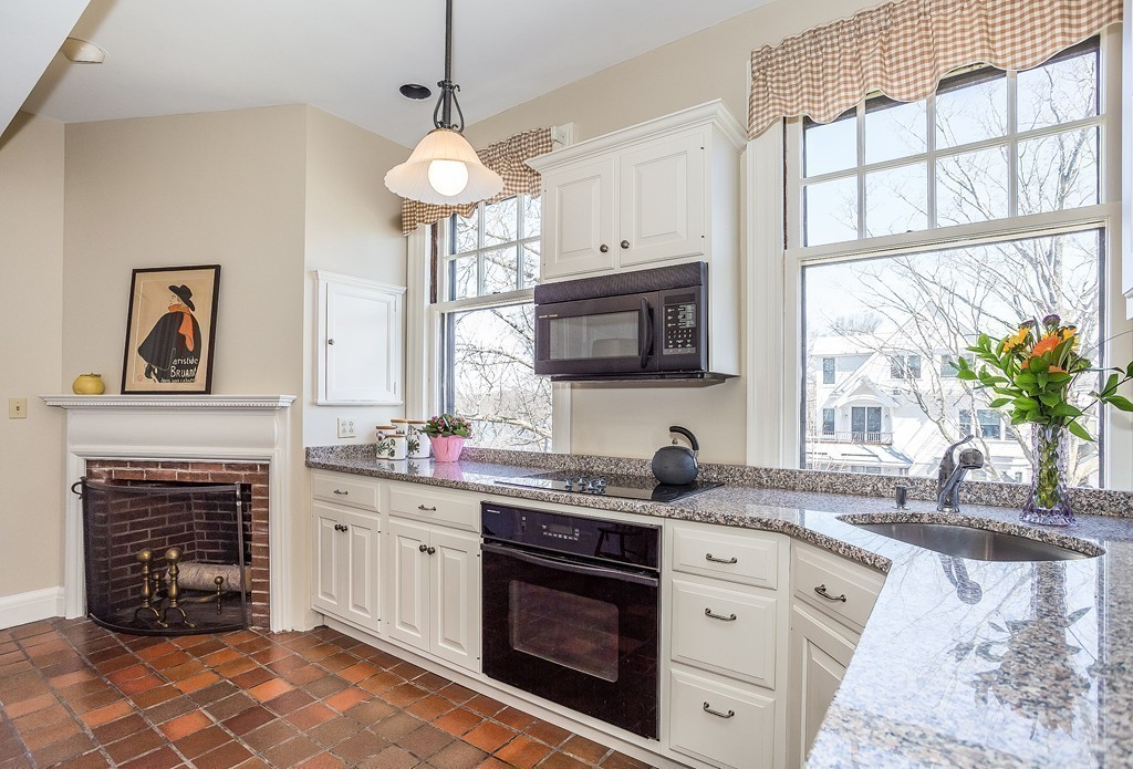 100 Pond Street, Unit 6 Boston, MA 02130 - Photo 4 of 29 a kitchen with stainless steel appliances a stove sink and cabinets