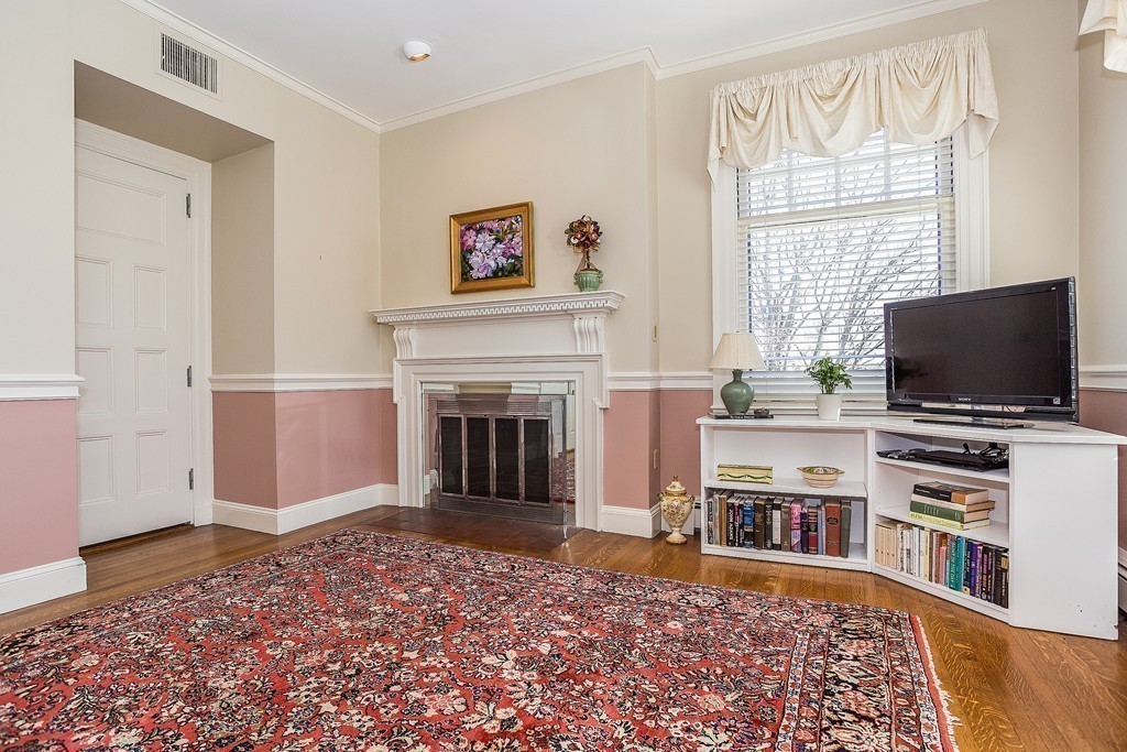 100 Pond Street, Unit 6 Boston, MA 02130 - Photo 10 of 29 a living room with a flat screen tv and a fireplace