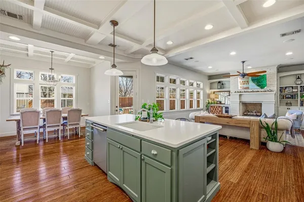 a view of a dining room with furniture a chandelier and wooden floor