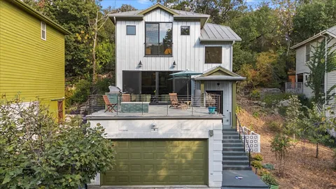 a front view of a house with yard and sitting area