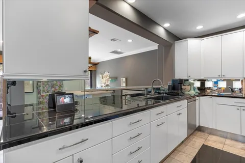 a kitchen with kitchen island a refrigerator stove microwave and cabinets