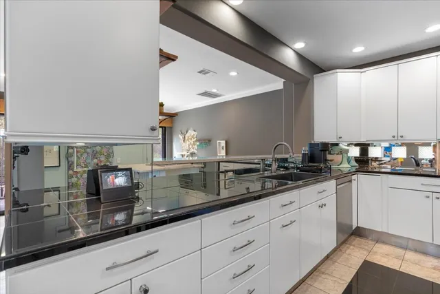 a kitchen with kitchen island a refrigerator stove microwave and cabinets