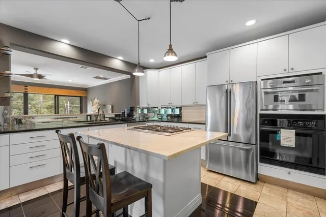 a balcony with wooden floor and outdoor seating