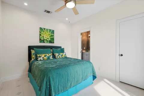 a bed sitting in a room next to a window