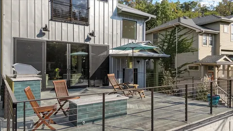 a view of a house with backyard porch and sitting area