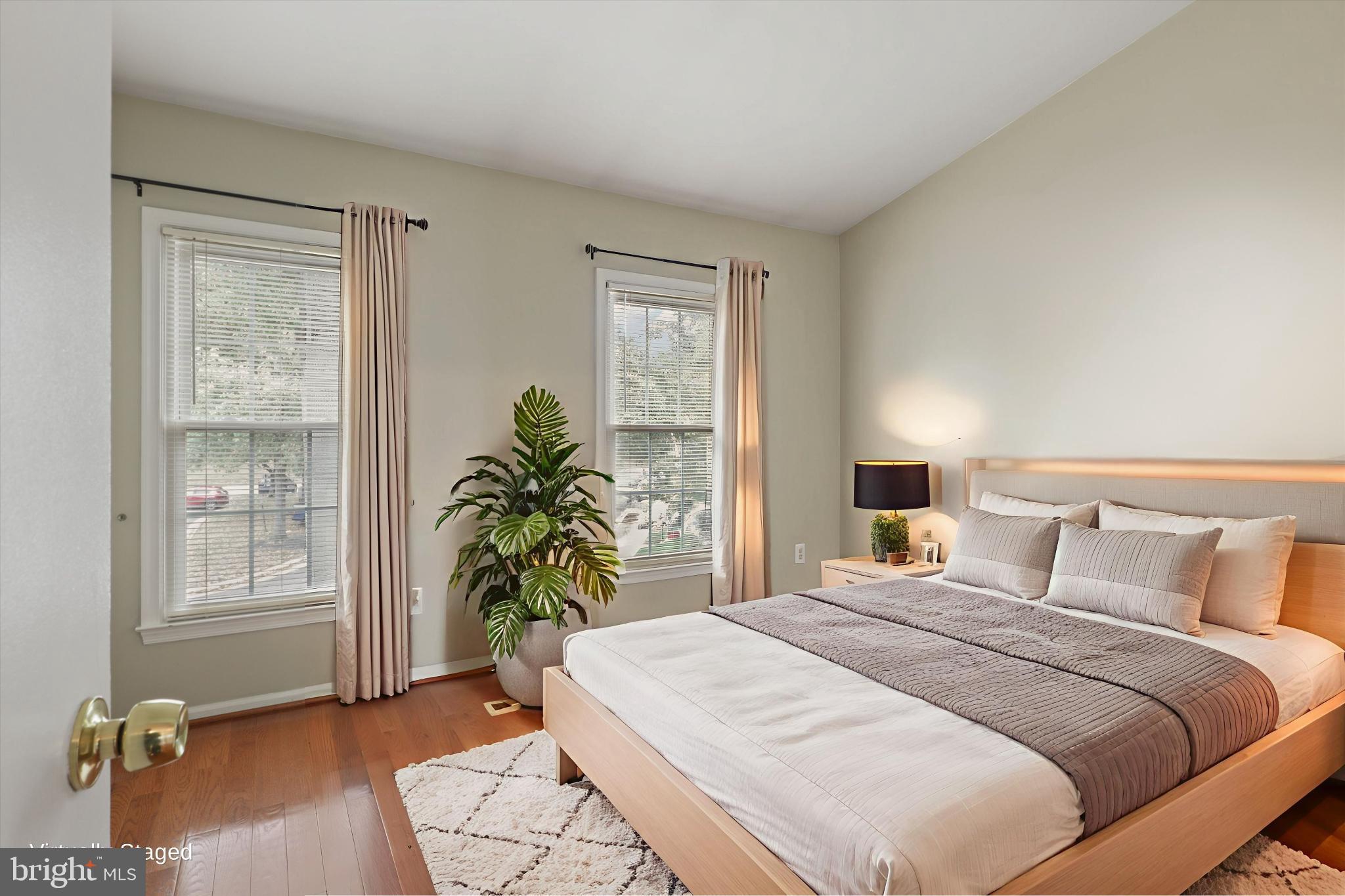 8564 Springfield Oaks Drive Springfield, VA 22153 - Photo 12 of 28 a bedroom with a bed windows and wooden floor