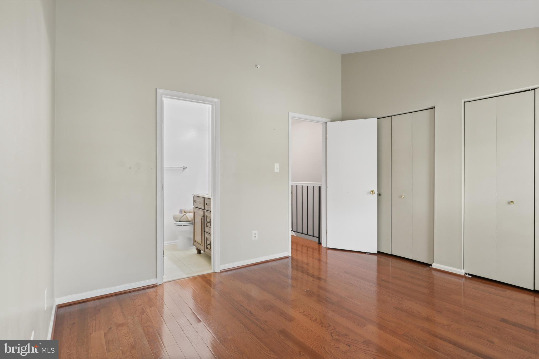 8564 Springfield Oaks Drive Springfield, VA 22153 - Photo 14 of 28 a view of an empty room with wooden floor and windows