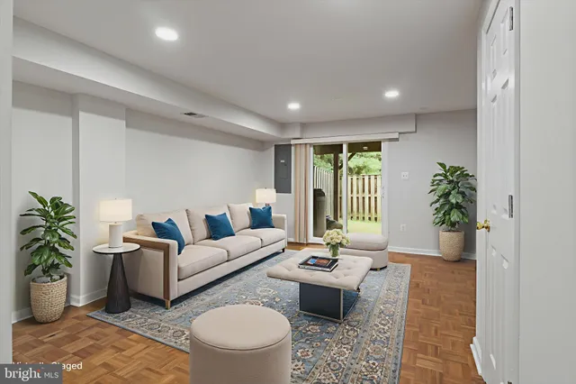 a living room with furniture potted plant and a table