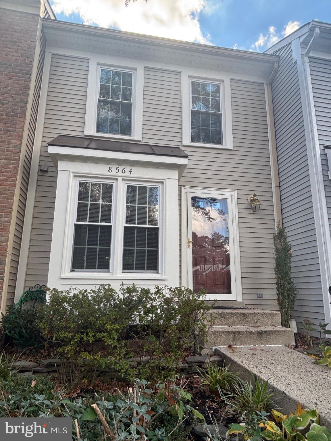 8564 Springfield Oaks Drive Springfield, VA 22153 - Photo 2 of 28 a front view of a house with garden