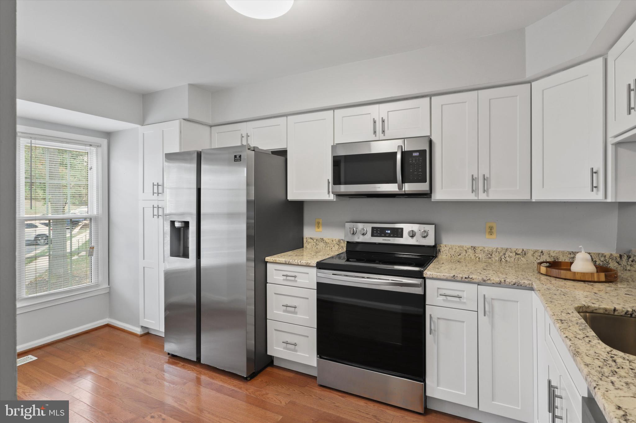 8564 Springfield Oaks Drive Springfield, VA 22153 - Photo 4 of 28 a kitchen with cabinets stainless steel appliances and a window